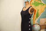 Side view of the vintage black Betsey Johnson dress with white buttons.
