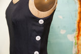 Vintage Betsey Johnson black dress with three white buttons on the side.