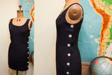 Vintage Betsey Johnson black dress side with vertical white buttons.