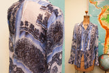 Vintage Gaultier silk blouse with intricate blue pattern and pleated detailing.