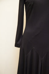 Edith Flagg black dress with a long sleeve and geometric chevron skirt seam.