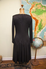 Vintage Edith Flagg black dress, back view with pleated 1920s-style drop waist.