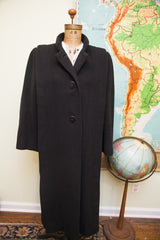 Vintage Trigere black wool coat with 40s fashioned sculpted shoulders.