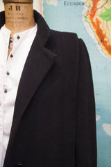 Vintage Trigere black wool coat's textured fabric and prominent button.