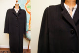 Textured black wool fabric and button detail of a vintage Trigere coat.