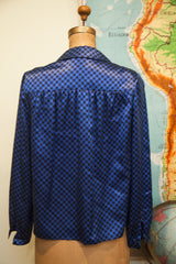 Gathered back detail and blue and black checker pattern of Mr. Beene blouse.
