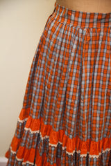 Vintage 50s squaredancing skirt with tiered orange ruffles and white lace trim.