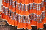 Ruffled orange and blue plaid tiers with white lace on the vintage squaredancing skirt.