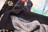 Ciprea Studio brand tag on the black ribbed collar of the vintage knit sweater.