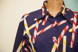 Vintage buttondown blouse, candy cane pattern on navy fabric with visible collar and buttons.