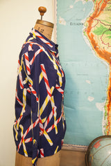 Side view of vintage Christian Dior blouse with red, white, yellow candy cane stripes.