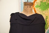 Draped neckline, shoulder bow, and pleated bodice of the vintage black romper.