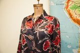 Vintage Moschino Buttondown Blouse, black with vibrant red floral print and white logo.