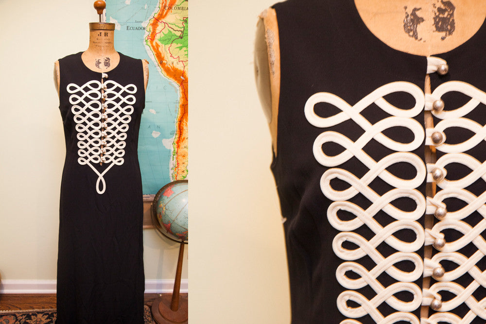 Vintage Moschino long black dress with intricate white looped piping on the bodice.