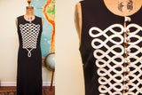 Vintage Moschino long black dress with intricate white looped piping on the bodice.