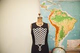 Vintage Moschino black dress with intricate white frogging-style piping on the bodice.