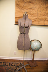 Adjustable lower body and metal base of the vintage grey dress form, with blue globe.