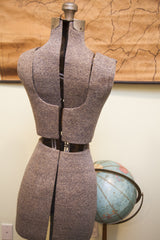 Lower grey textured fabric section of the vintage petite dress form's adjustable panels.