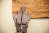 Upper back of adjustable dress form, showing mottled grey fabric panels and metallic top.