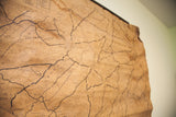 Angled view of the vintage 1930s NY map with visible creases and staining.
