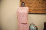 Pink Patty Woodard dress bodice adorned with pearls and pleated skirt.