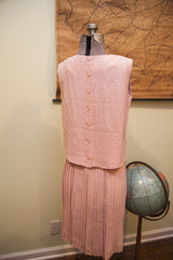 Back view of vintage pink Patty Woodard sleeveless top with buttons and pleated skirt.