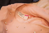 Patty Woodard pink dress label, care instructions, with pearls and rhinestones.