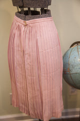 Pleated texture and button closure on the vintage pink Patty Woodard skirt.