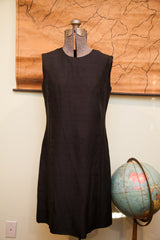 Vintage black Mancini dress featuring a sleeveless cut and classic shift silhouette.