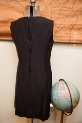 Back view of the vintage black silk dress showing its long zipper closure.