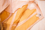 Interior of vintage 50s Carole King pink taffeta dress, showing orange lining and brand label.