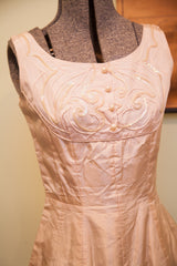 Vintage Carole King pink taffeta dress showcasing fitted waist and draped skirt.