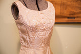 Intricate sequined embroidery and pearl details on the vintage pink taffeta dress bodice.