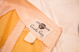 Carole King Junior Fashions label on pink dress fabric with yellow lining and zipper.