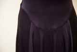 Black Betsey Johnson dress with a curved waist seam and soft skirt folds.