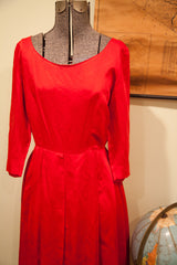 Vintage 50s red dress showing its lustrous satin fabric and low waistline.
