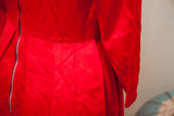 Lustrous fabric and side zipper detail on the vintage 50s red dress with a low waistline.