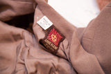 Anne Klein 100% wool label and 'Made in USA' tag on light brown suit lining.