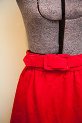 Red velvet matching belt with covered buckle on the Nelly De Grab skirt.