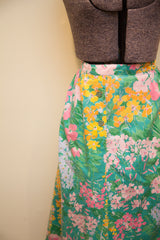 Close up of side buttons on vintage Herman Geist skirt with vibrant floral print.