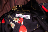 Casso Line label on black velvet vintage dress with red floral pattern.