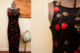 Close-up of vintage black velvet dress bodice with red tulip floral pattern.