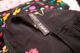 Betsey Johnson label sewn into black vintage floral dress fabric.