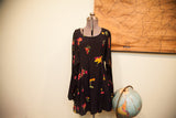 Flared skirt of the black Betsey Johnson dress, featuring bright floral patterns.