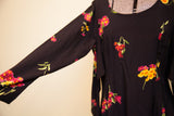 Betsey Johnson dress featuring scoop neck, shoulder, and vibrant floral print.
