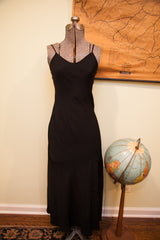 Betsey Johnson Black Slip Gown with V-neckline and spaghetti straps on mannequin.