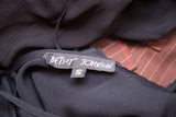 Betsey Johnson brand tag and size S label on black slip gown fabric.