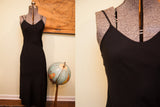 Betsey Johnson black slip gown, smooth matte fabric and fitted silhouette.