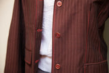 Brown pinstripe blazer with bright red stitching and button detail.