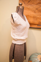 Vintage white crop top featuring textured knit pattern and winged sleeve.
